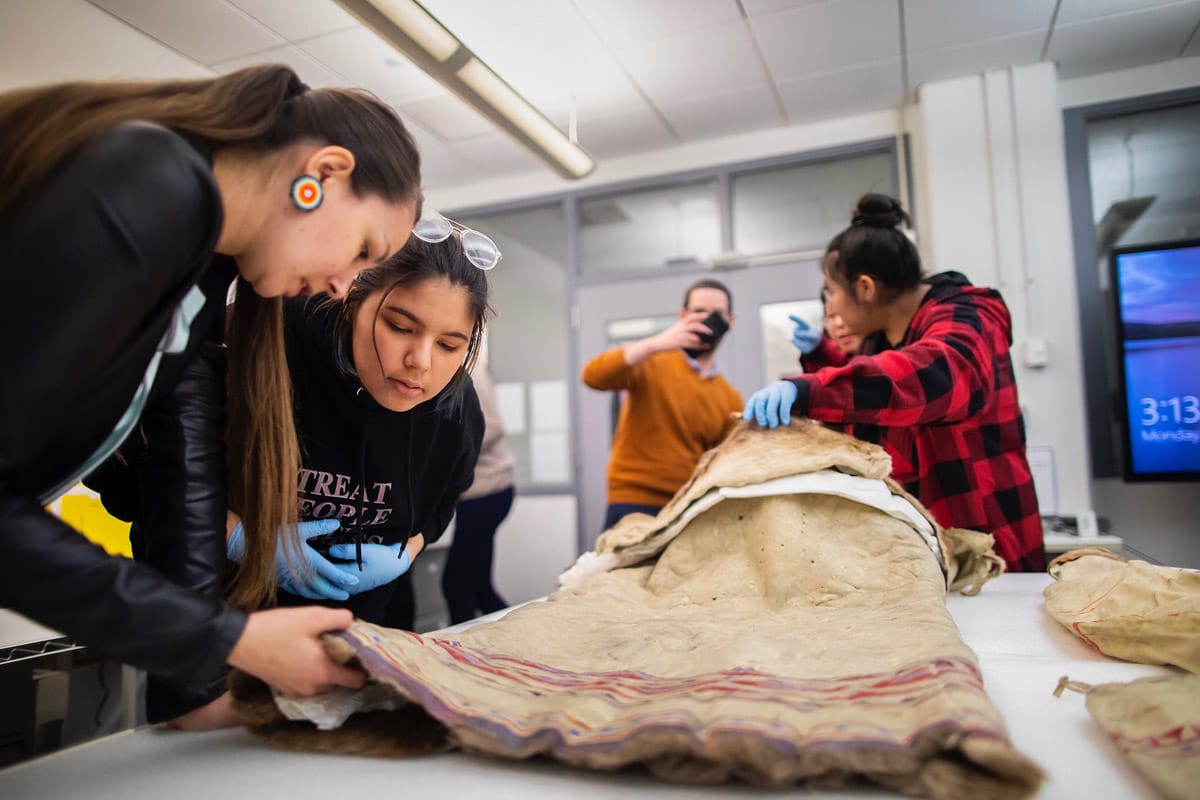 Penn students examining anthropological materials in the Collections Study Room at the Penn Museum.