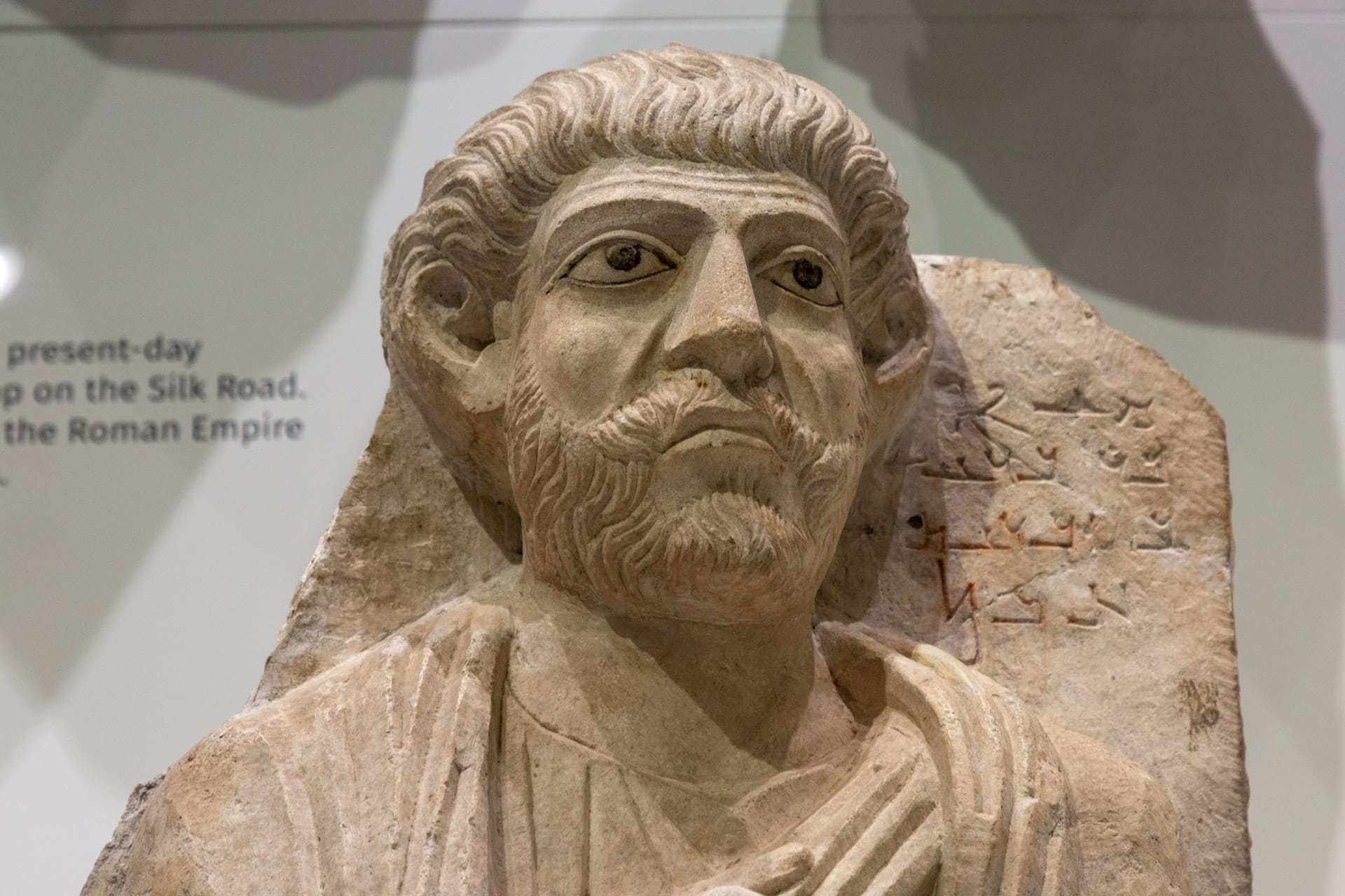 A limestone portrait preserves the likeness of a man who lived in ancient Palmyra, a desert oasis in present-day Syria. The inscription beside the sculpture’s head, written in the Palmyrene dialect of Aramaic, reads: “Ma’an, son of Bar’a, son of Zabd’ateh. Alas!” This object came into the Penn Museum’s collection in 1890 through the second Babylonian Expedition, one of the institution’s earliest field projects.