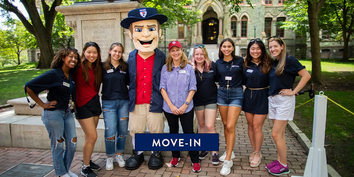 President Magill poses with a group of students and the Penn Quaker mascot in front of the Benjamin Franklin statue on College Green at the University of Pennsylvania..