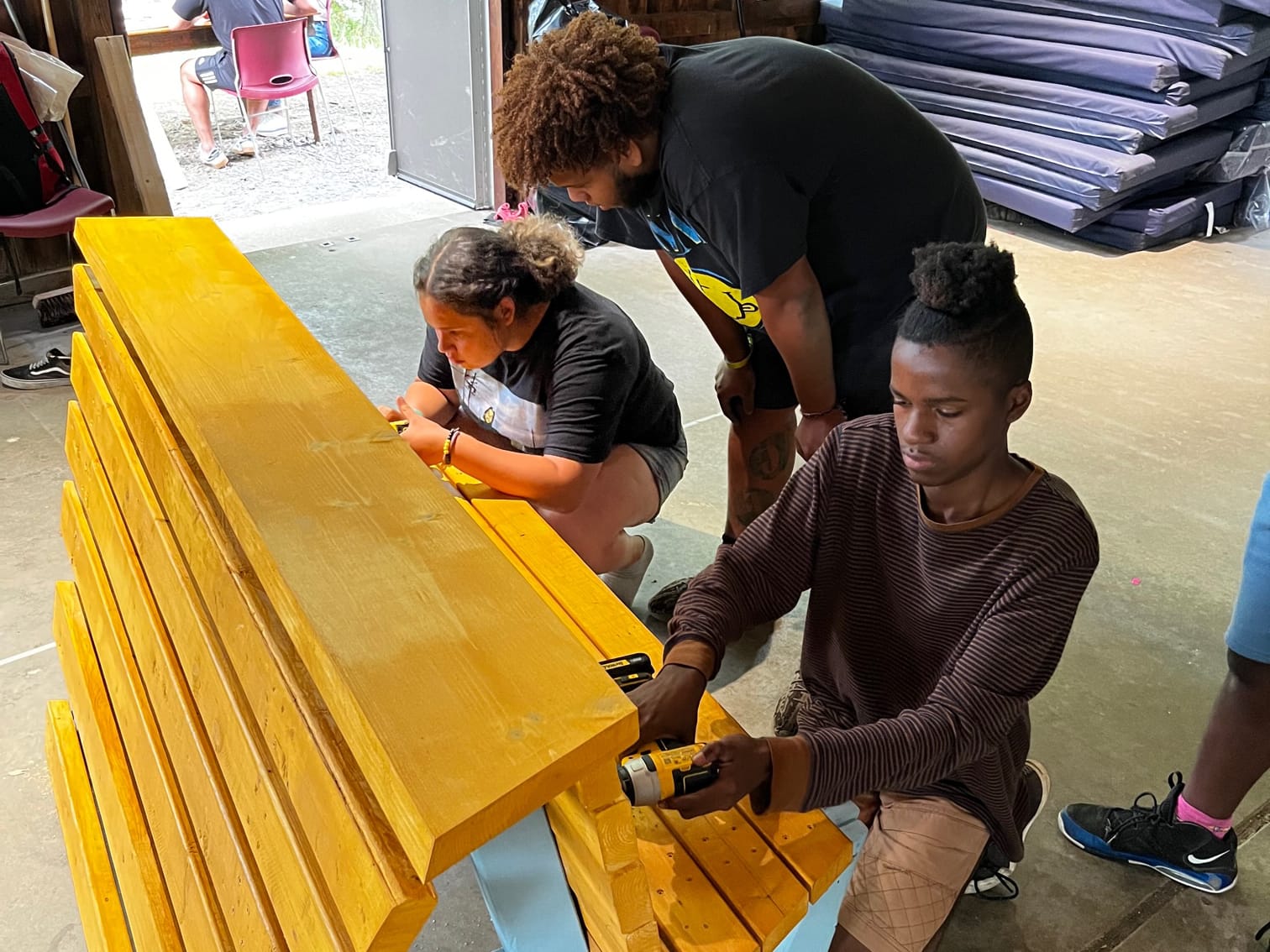 Students crafting a bench