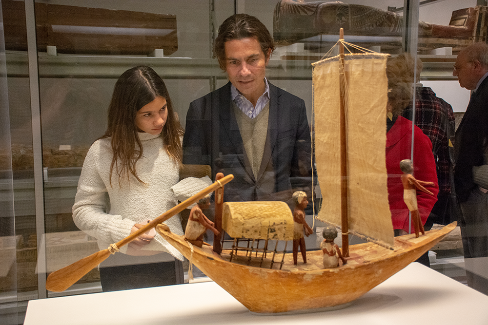 father and daughter looking at a boat model