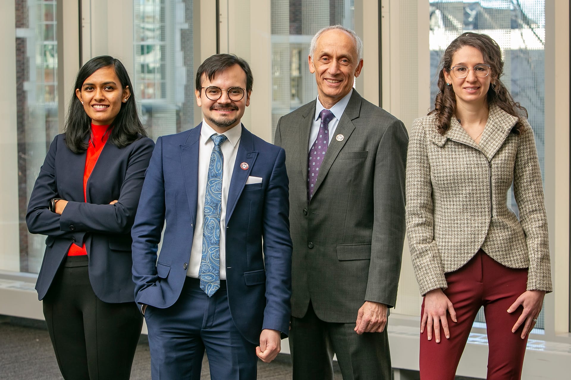 Four members of Penn Dental's Center for Integrative Global Oral Health, Ankita Shashikant Bhosale, Alonso Carrasco-Labra, Michael Glick, and Olivia Urquhart, pose together as a group. Photo credit: Kevin Monko.