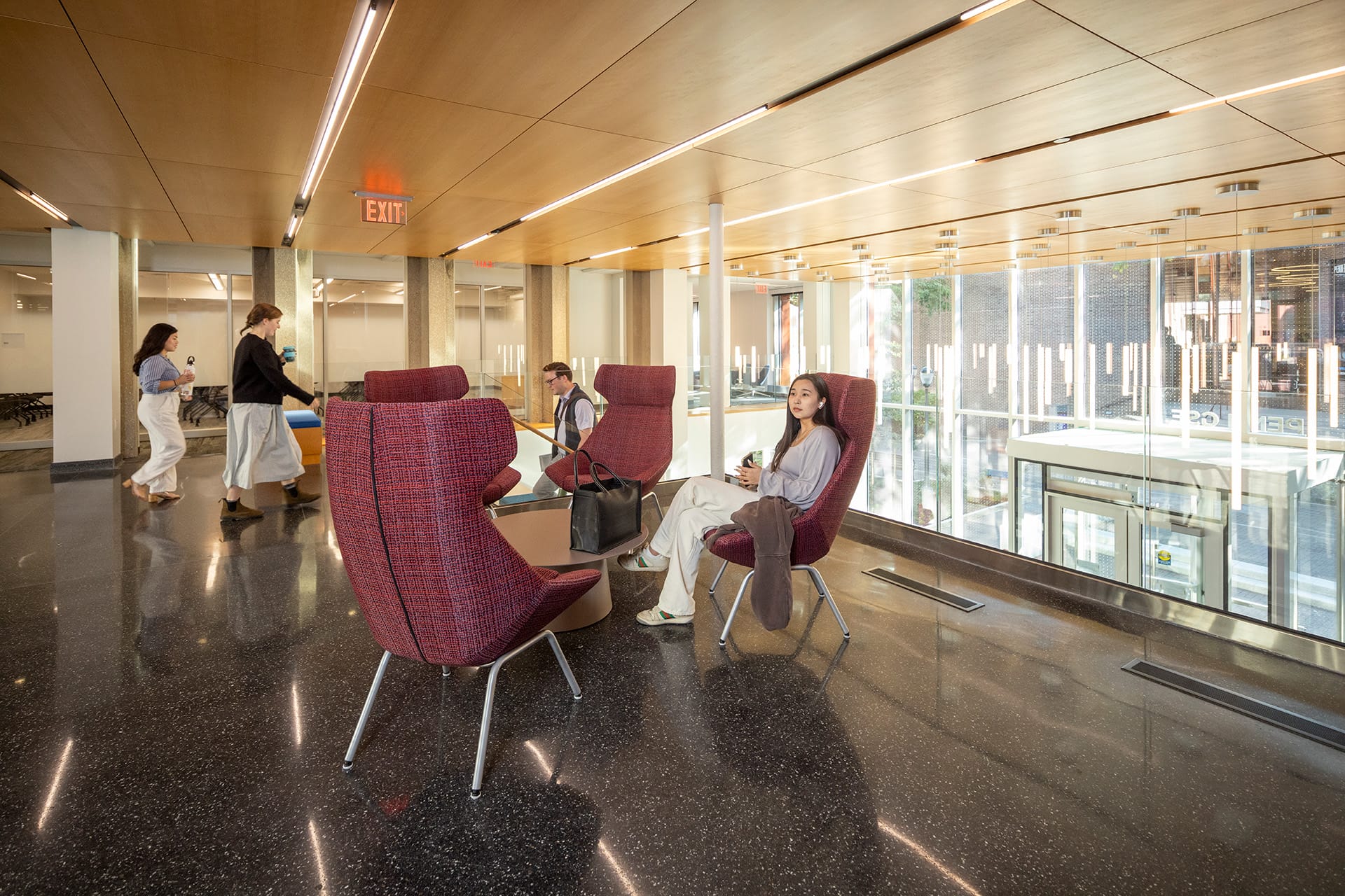 A students sits contemplatively in the Pollack/Usdan Overlook, which offers natural light and views of campus