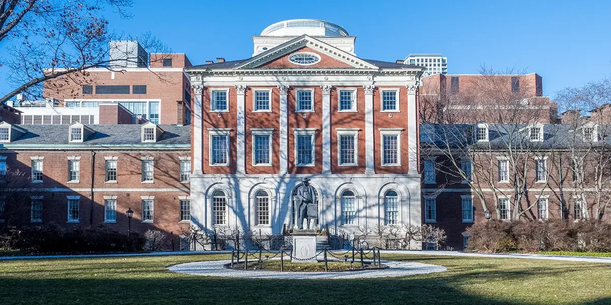 Exterior of Pennsylvania Hospital, with a statue centered in front of the historic brick building.