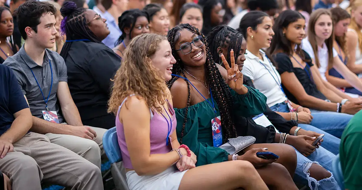 Incoming Penn students smile and chat during Convocation, representing the sense of community supported by The Penn Fund.