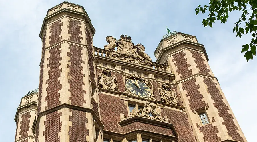 The Provosts' Tower at Penn, photographed from below with leafy branches in frame, symbolizing the strength and reach of unrestricted giving.