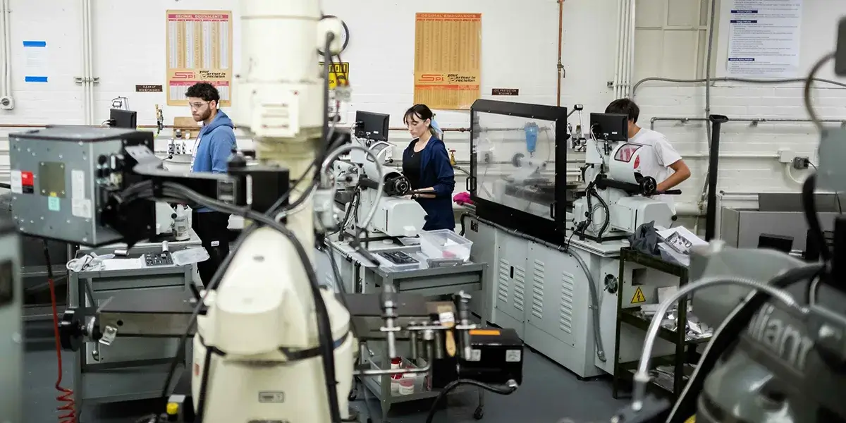 Students work with machinery and equipment in a Penn Engineering lab.